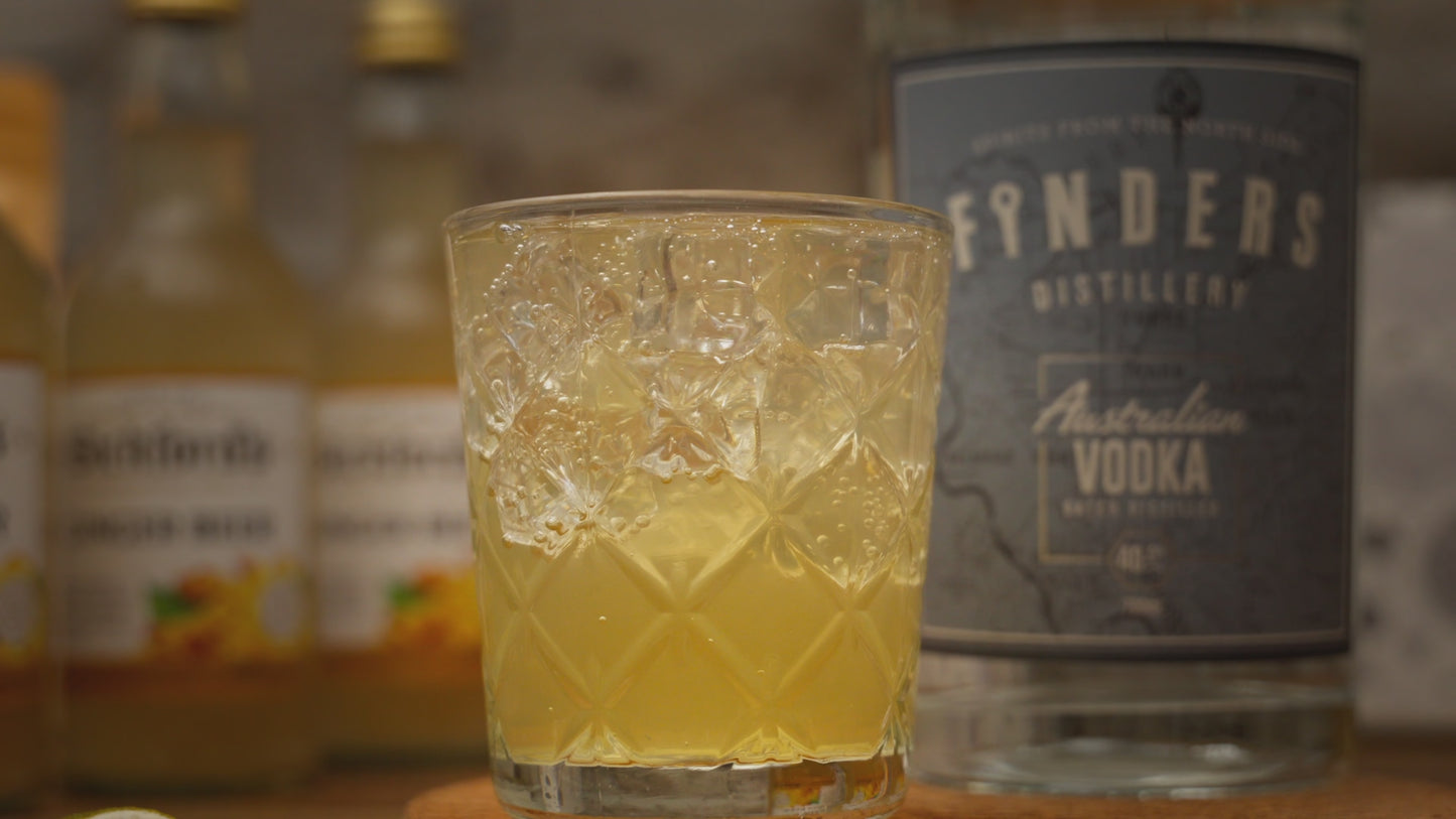 Moscow Mule Cocktail Kit showing the cocktail, with the kit contents around it including Finders Distillery Vodka, Bickford's ginger beer and dried lime slices. 