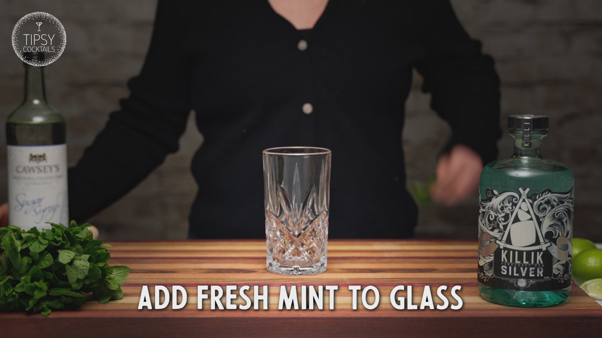 Recipe video showing how to make a Mojito cocktail. Starting muddling mint leaves and a lime wedge at the base of the glass. Add 45ml of white rum and 15ml of sugar syrup. Top with ice and pour in soda water to the top of the glass. Give the drink a stir. Garnish with dried lime slice and a sprig of fresh mint. Enjoy!