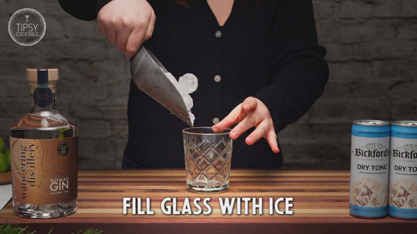 Video shows recipe of how to make a classic gin and tonic cocktail. Fill your glass with ice and pour in 45ml of the Wandering Distillery Nomad Gin. Add in a good squeeze of fresh lime juice and give it a good stir. Top with tonic water and garnish with dried lime slice. Enjoy!