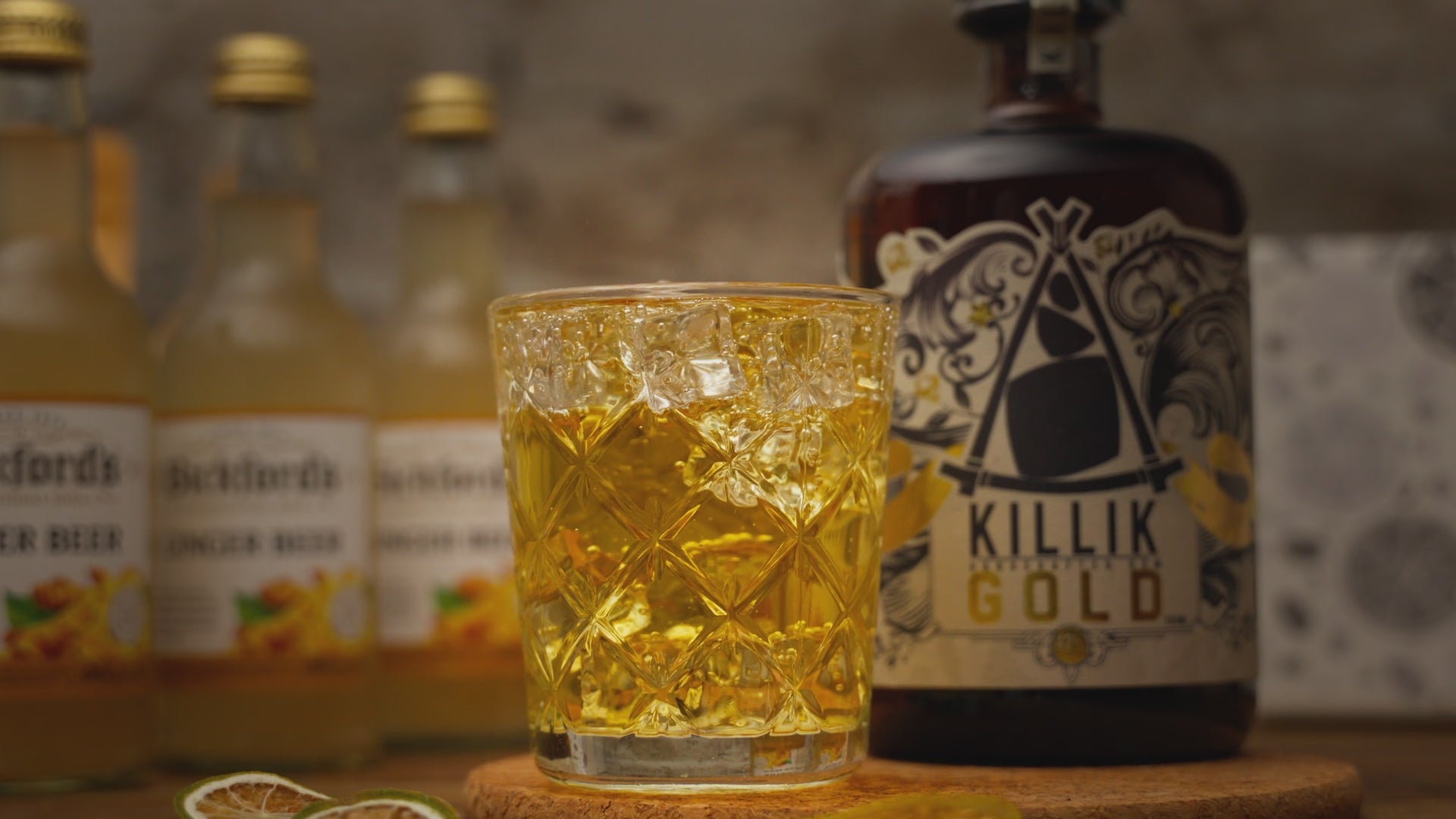Video shows a hand placing a dried lime garnish into The Forecast cocktail, with its cocktail kit contents around it including a bottle of Killik Gold, Bickford's ginger beer and dried lime slices. Video ends with a quick reverse of the garnish going into the drink