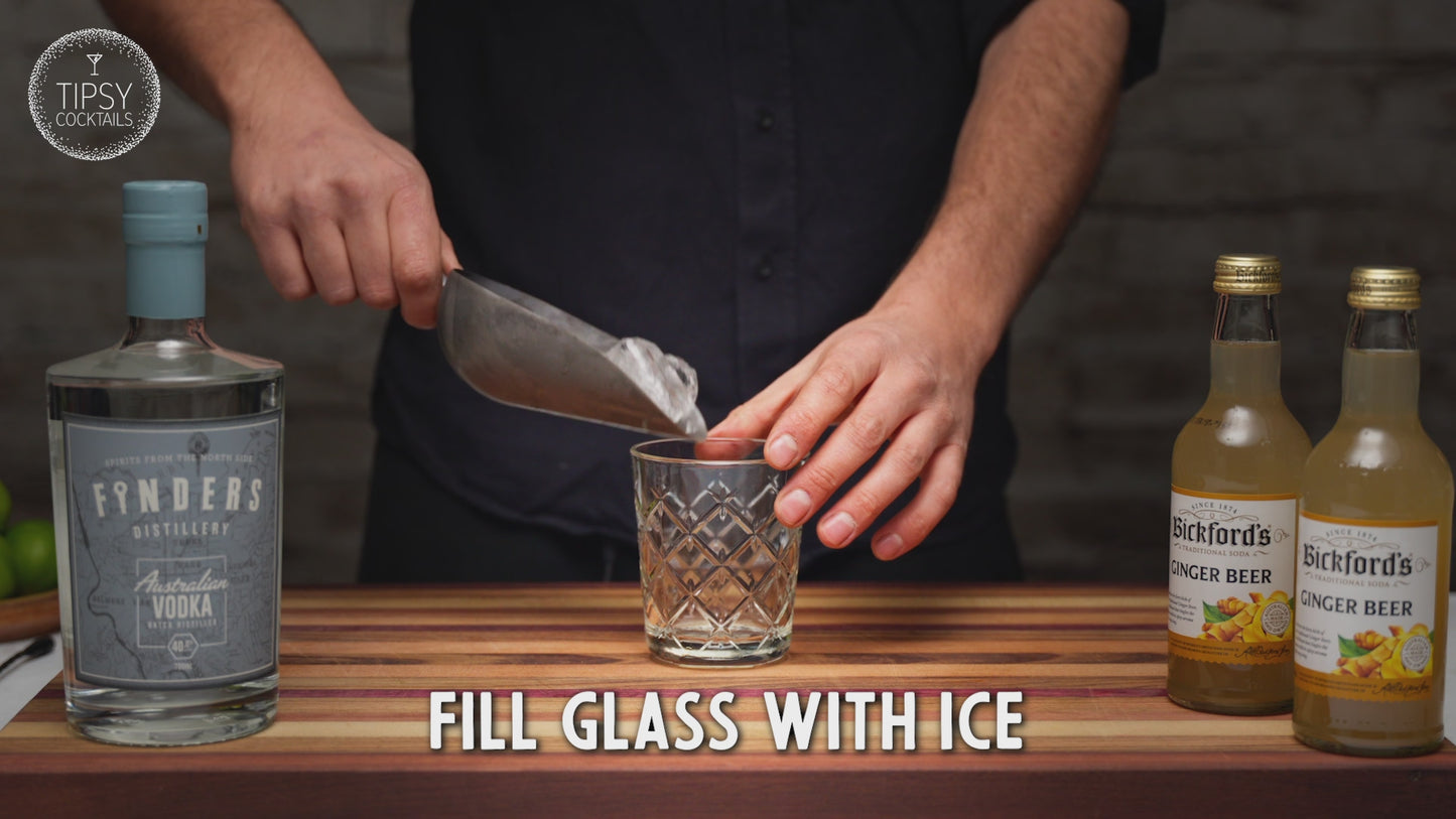 Video showing recipe for making a moscow mule cocktail. Fill your glass with ice. Add 45ml of vodka, a good squeeze of fresh lime and top with about 140ml of ginger beer. Garnish with a slice of dried lime and enjoy.